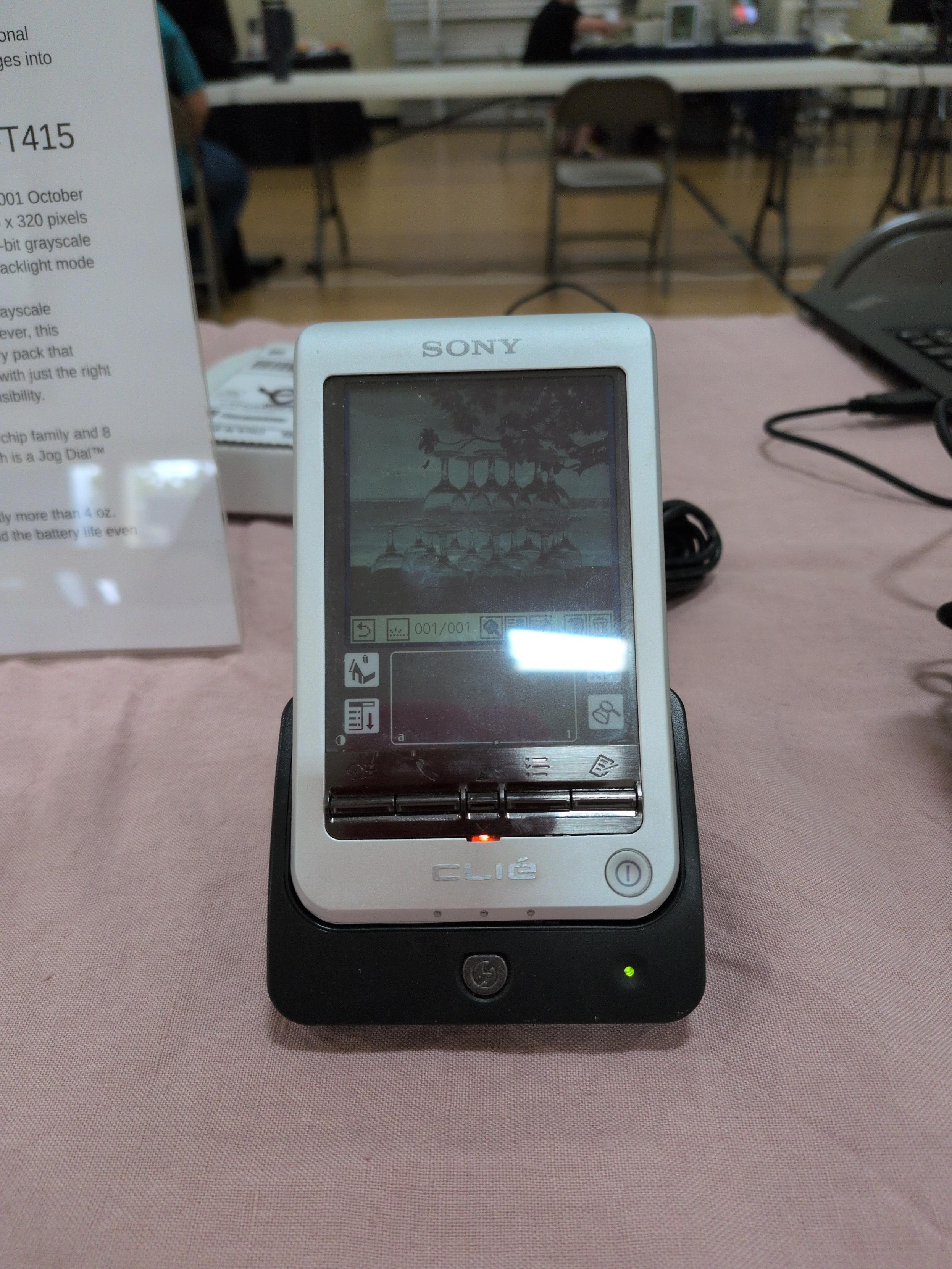 A Sony CLIÉ PEG-T415 showing off its resolution and grayscale with a photo of stacked clear drinking glasses